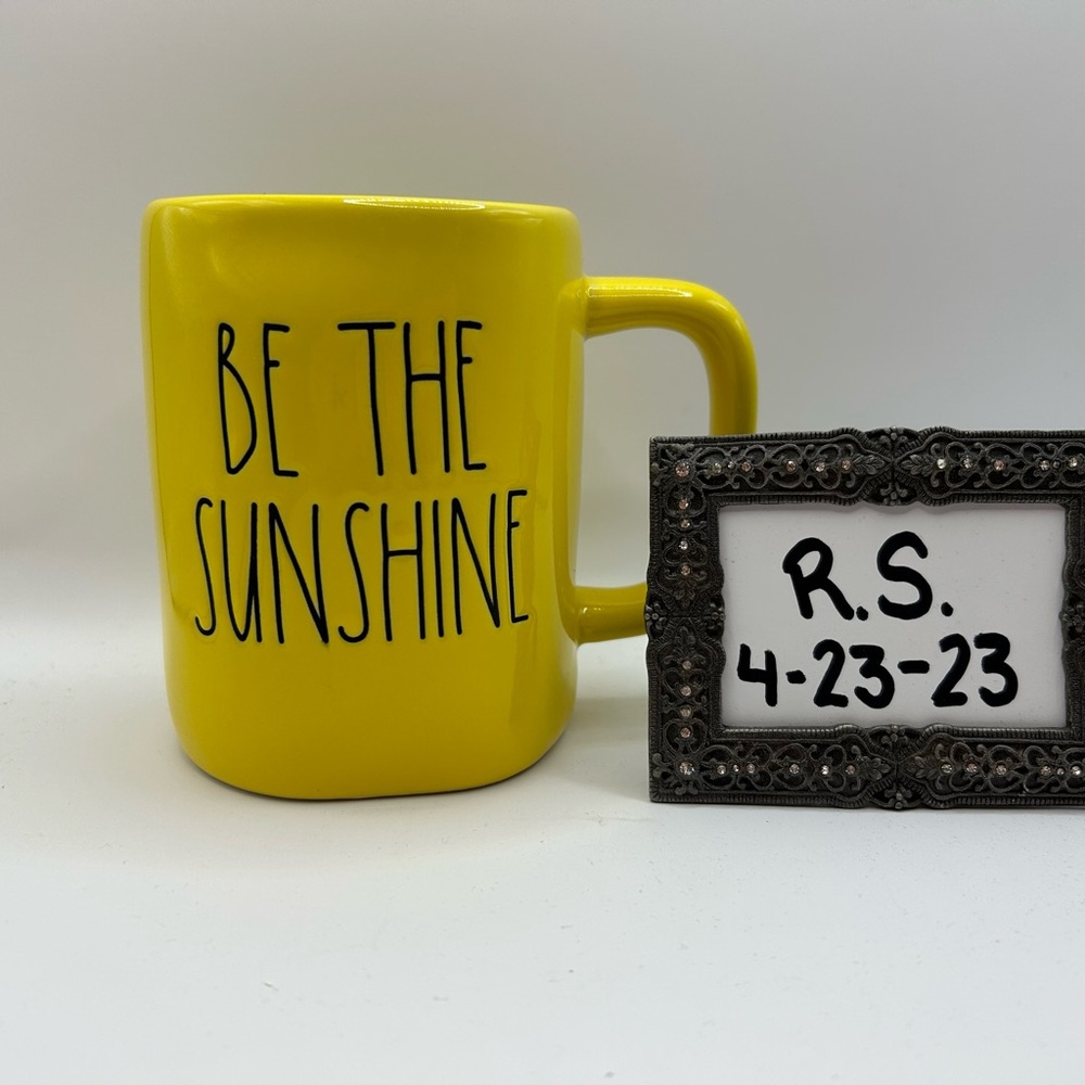 Rae Dunn yellow “Be the Sunshine” mug.